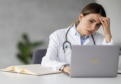 Portrait of female doctor in her office. People,healthcare and medical concept.She is having headache after hard day on work.